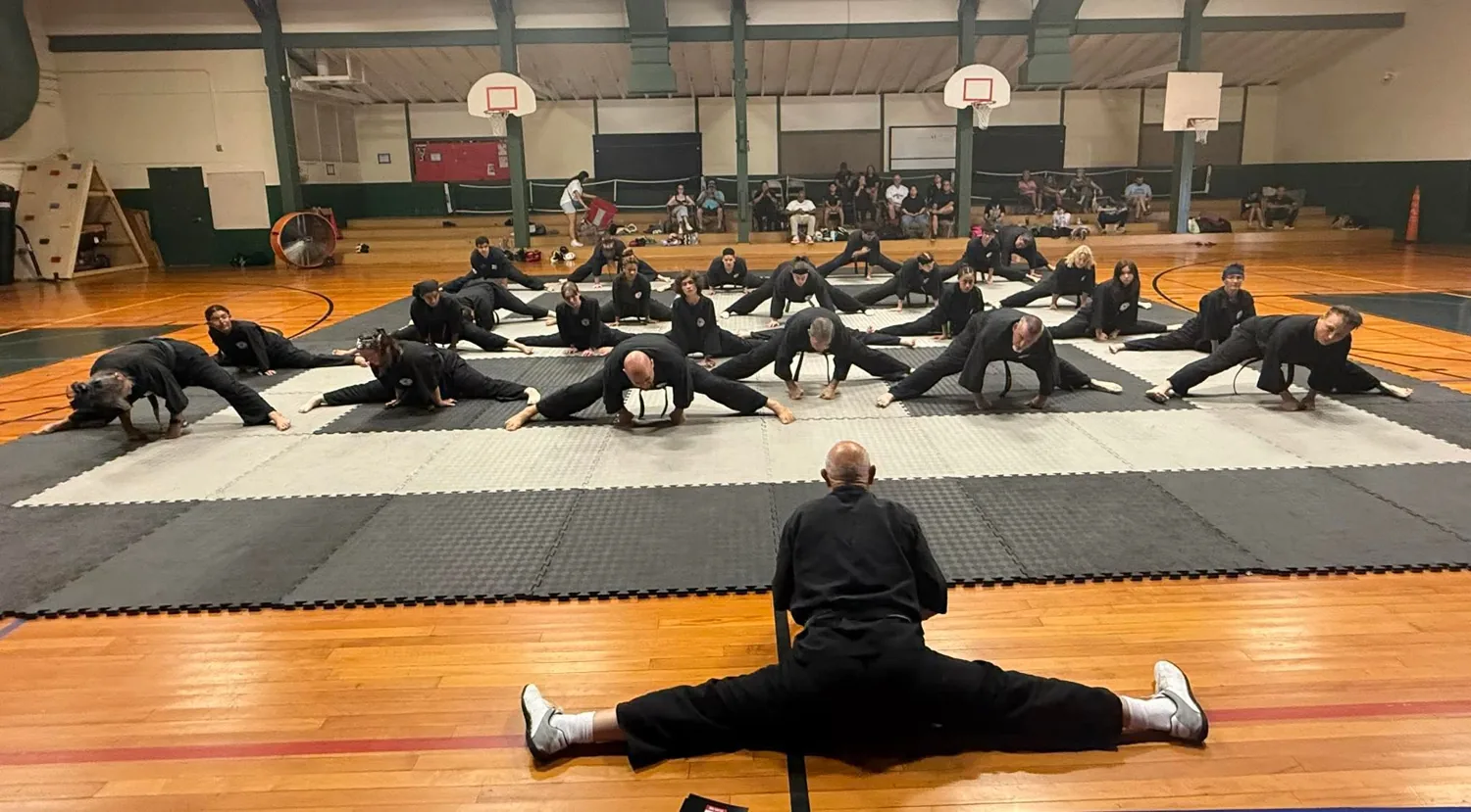 Martial artists practicing flexibility together